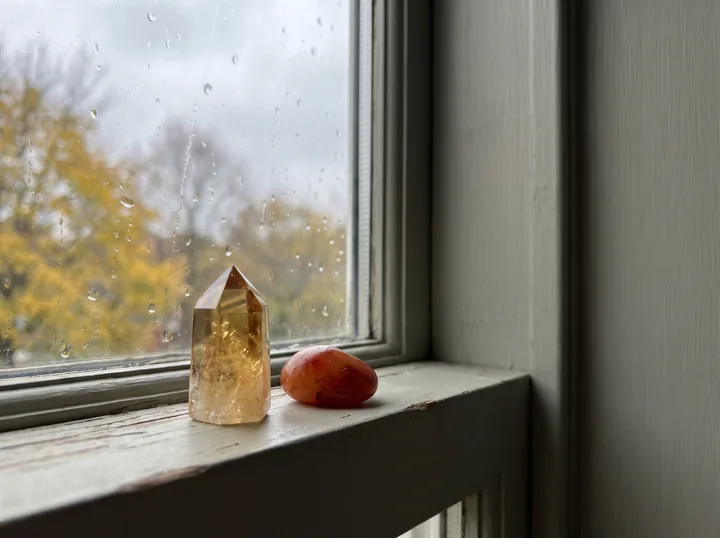 Citrine and carnelian on a windowsill on a rainy morning - stones for fading light